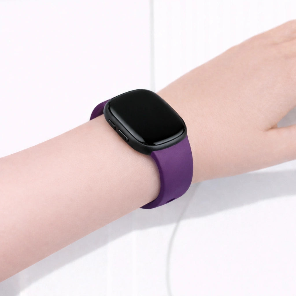 Dark purple Fitbit Versa 3 watch strap worn on the wrist for everyday comfort and secure fit