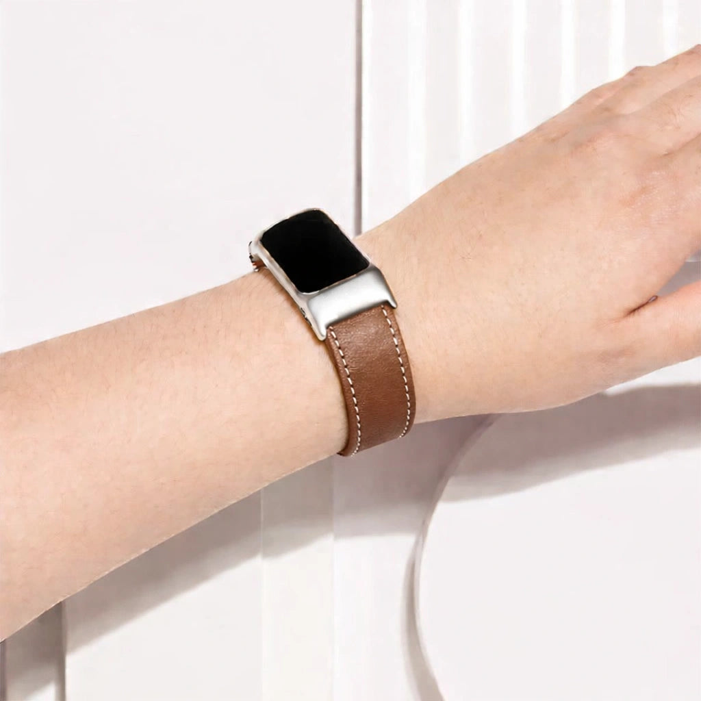 Dark brown leather Fitbit Charge 6 watch strap worn on the wrist