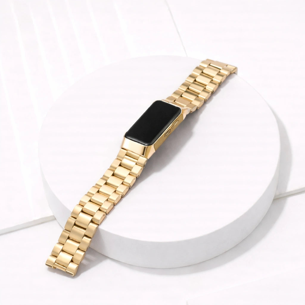 Gold stainless steel link strap for Fitbit Charge 6 shown in a minimalist flat lay setup