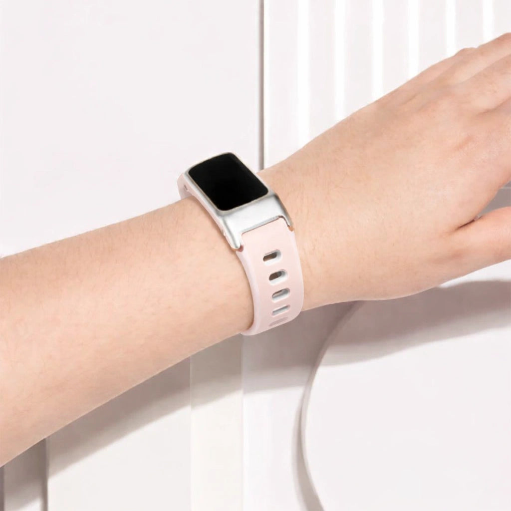 Fitbit Charge 6 worn with a light pink and white sports style replacement strap on user's wrist