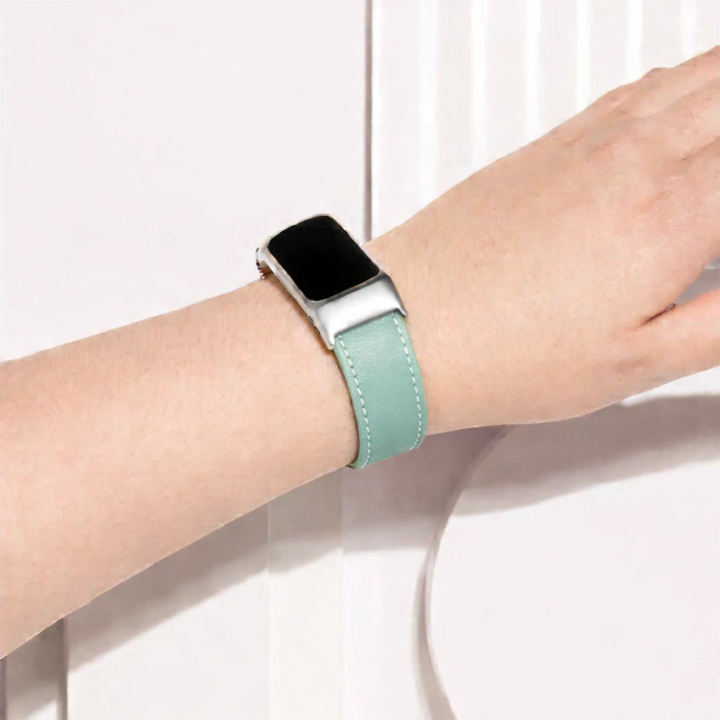 Mint leather Fitbit Charge 6 band worn on the wrist with silver case