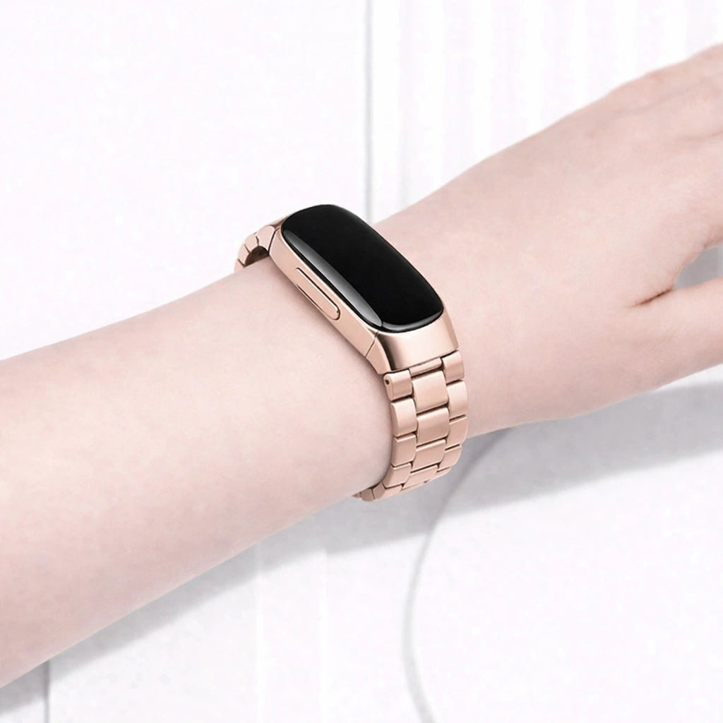Rose gold metal strap for Fitbit Inspire 2 worn on the wrist