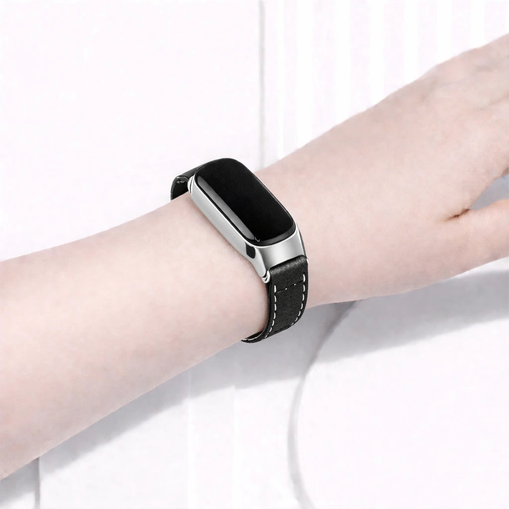 Black leather watch strap worn on a Fitbit Inspire 3