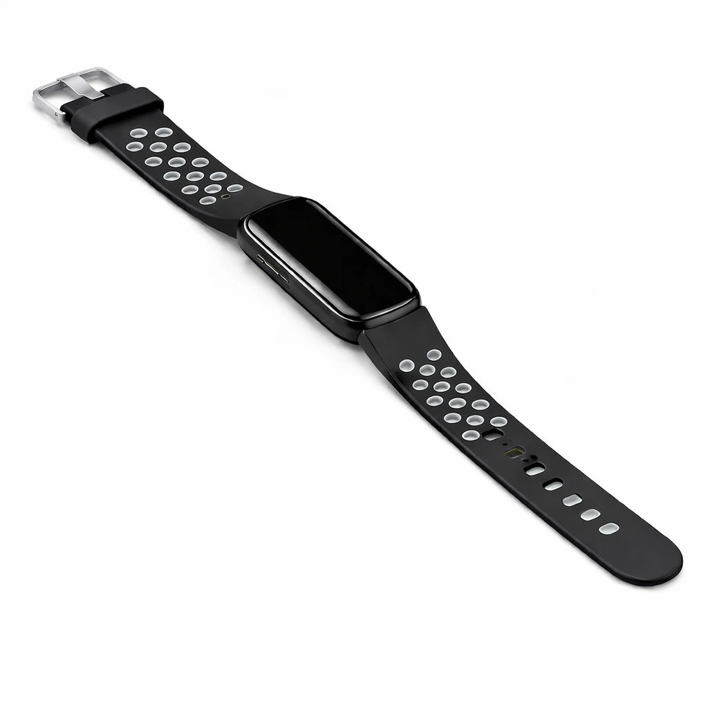 Flat lay image of a black and grey coloured sports strap for the Fitbit Luxe attached to the device.