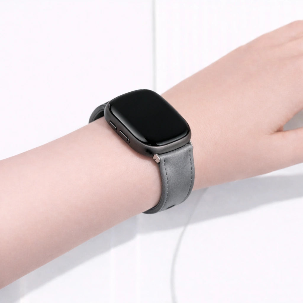 Grey leather watch strap for Fitbit Versa 3 worn on the wrist with a comfortable, everyday fit