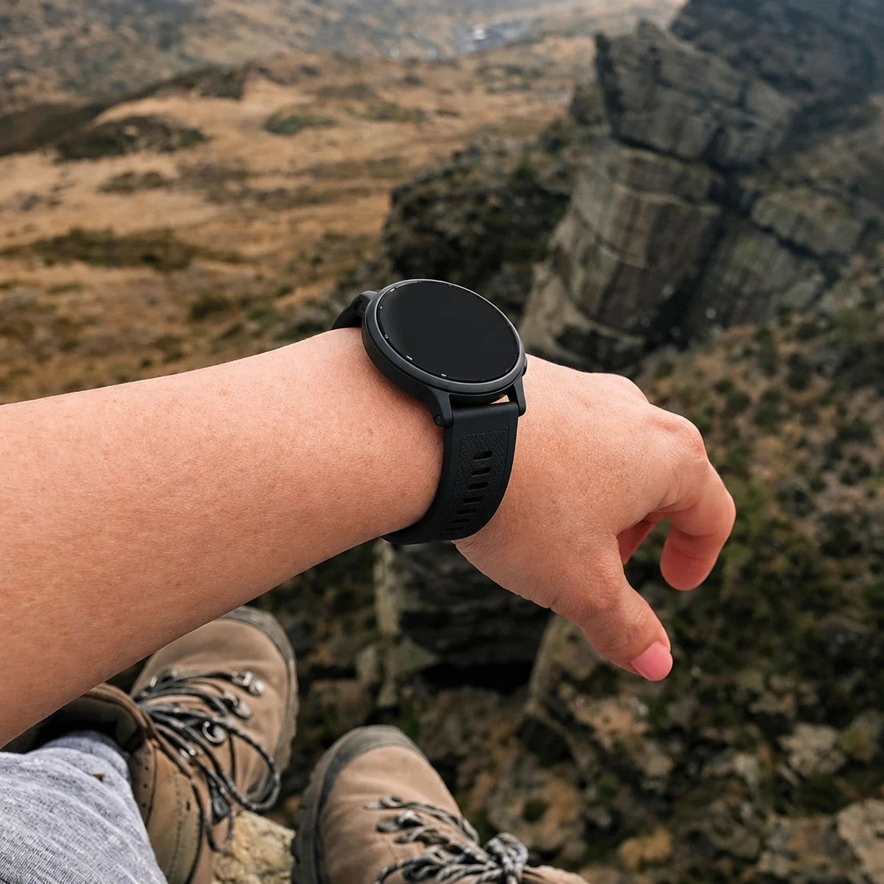 Black Garmin Venu 3S strap worn outdoors during a hiking adventure.