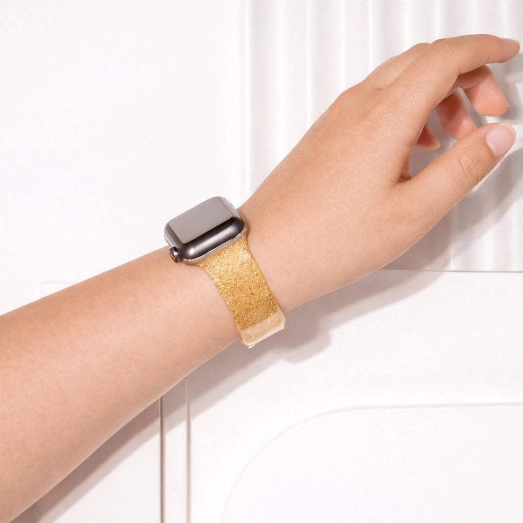 Gold glittery Apple Watch watch strap worn on wrist with bold shimmering finish