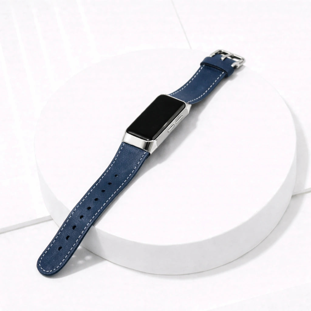 Fitbit Charge 5 navy leather watch strap with silver buckle shown on white platform