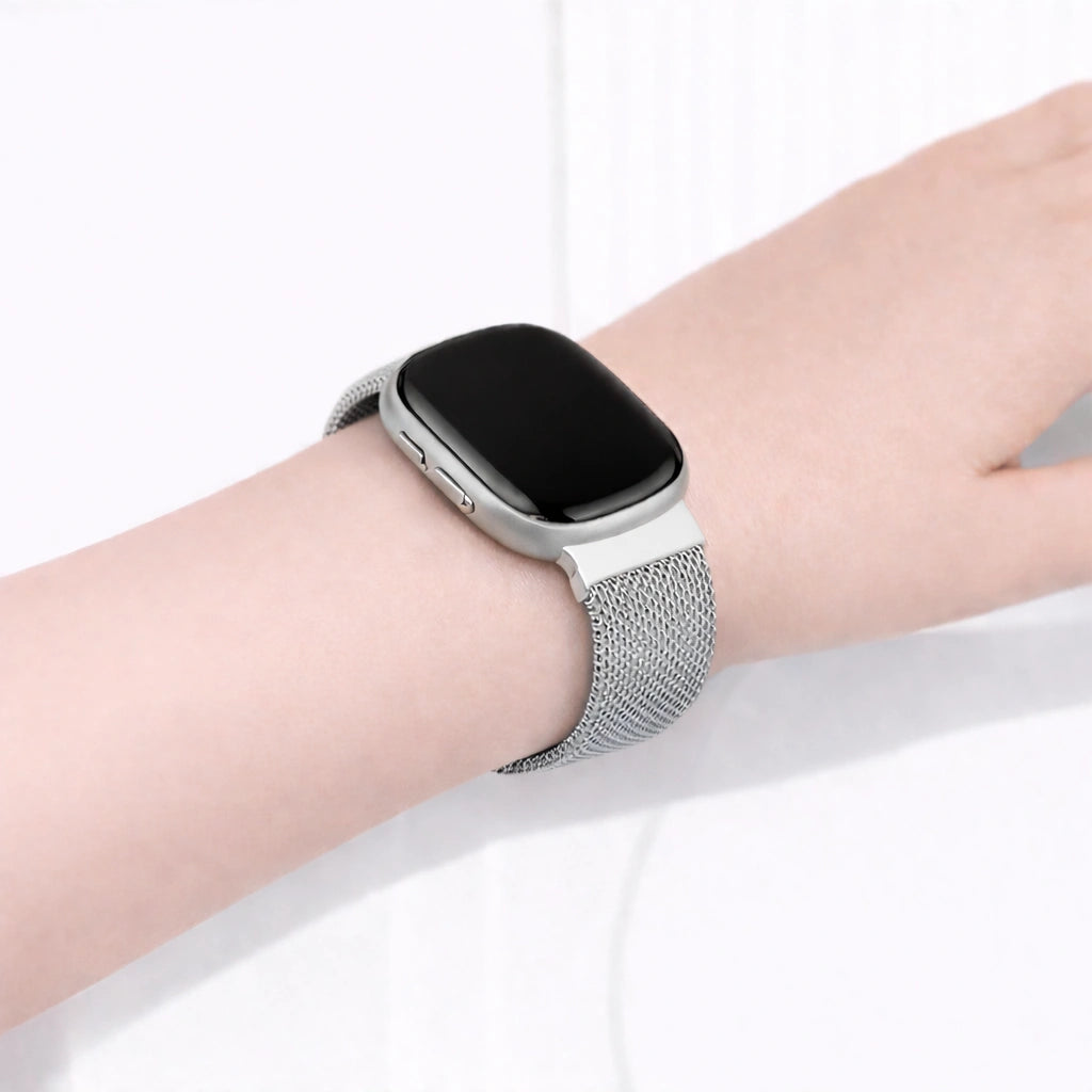Silver mesh watch strap for Fitbit Sense 2 shown on wrist with breathable metal design