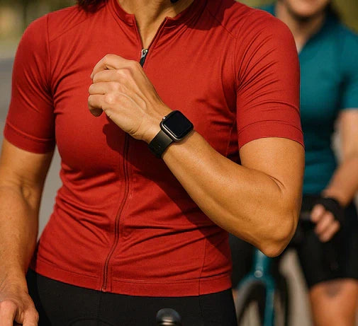 Cyclist in a red jersey wearing an Apple Watch during a ride