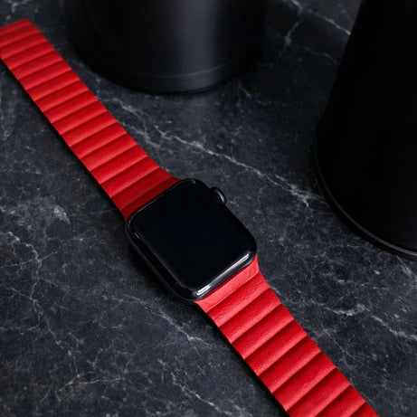 Apple Watch band laid flat on a surface, highlighting the band structure and flexibility
