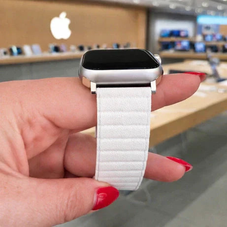 Unworn white Apple Watch band held inside an Apple Store, representing the condition required for a successful exchange