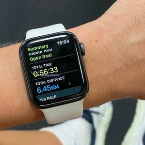 Close-up of an Apple Watch showing workout summary data with a white strap, used for identifying the model during fitness tracking.