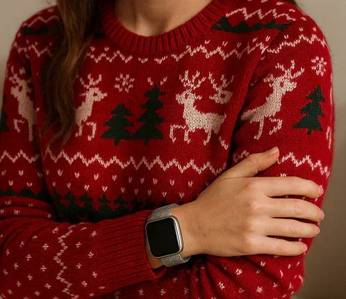 Gold Apple Watch strap worn with a navy Christmas jumper featuring a reindeer design