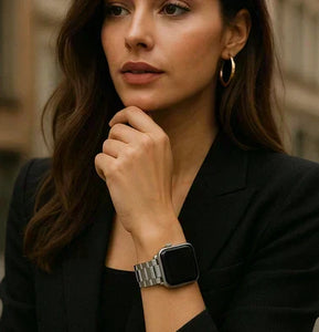 Fashionable woman wearing the best metal Apple Watch band in silver, styled with a black blazer