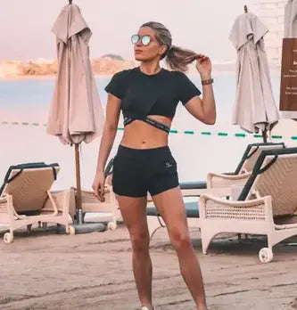 Woman wearing a Fitbit band for small wrists while walking by the beach