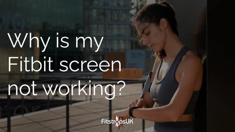 Woman checking Fitbit with unresponsive screen outdoors