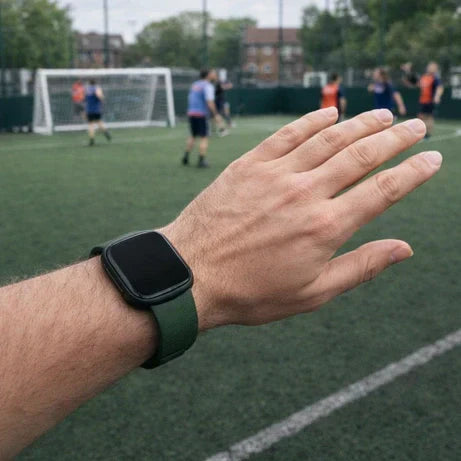 Fitbit Versa 4 band worn by a man during a five-a-side football game