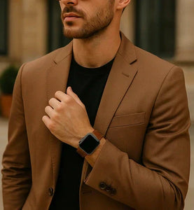 Man wearing a brown leather Apple Watch strap with a suit jacket, showcasing a smart casual look