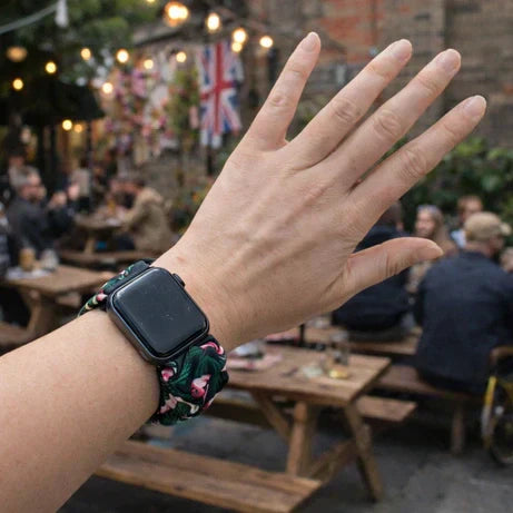 Scrunchie-style alternative Apple Watch strap worn outdoors in a casual setting