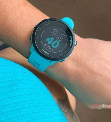 Close-up of a turquoise sports watch on someone’s wrist after a workout.