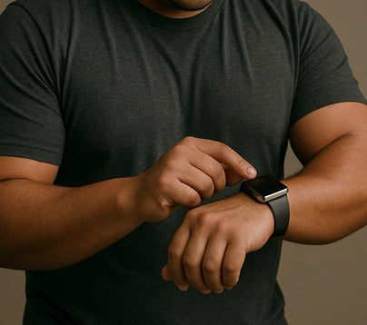 Man wearing an XL Apple Watch band with a black strap, adjusting settings on his fitness watch