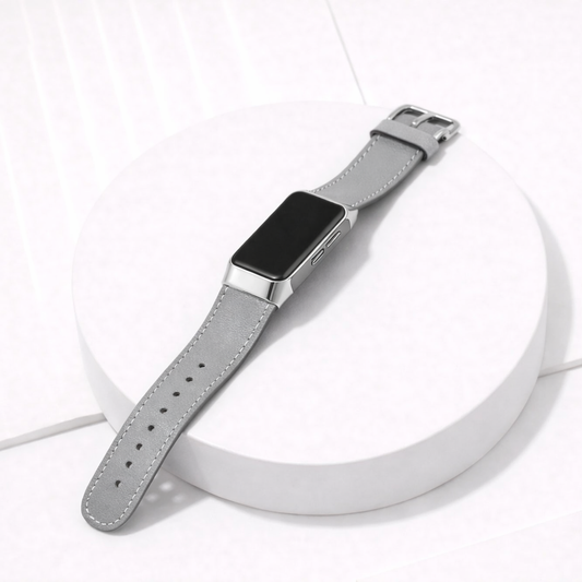 Grey leather Fitbit Charge 6 band worn on the wrist with silver case