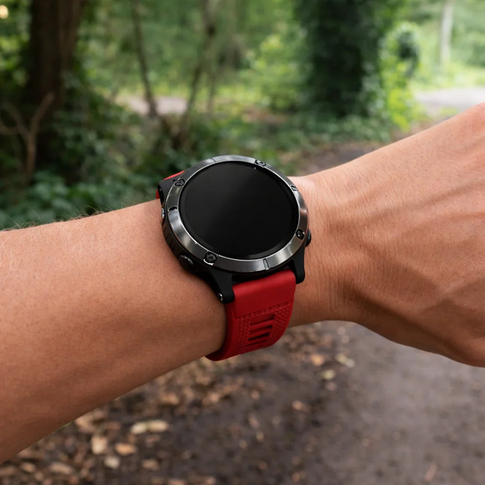 Red Garmin Epix Pro fitness watch with red silicone strap during an outdoor walk