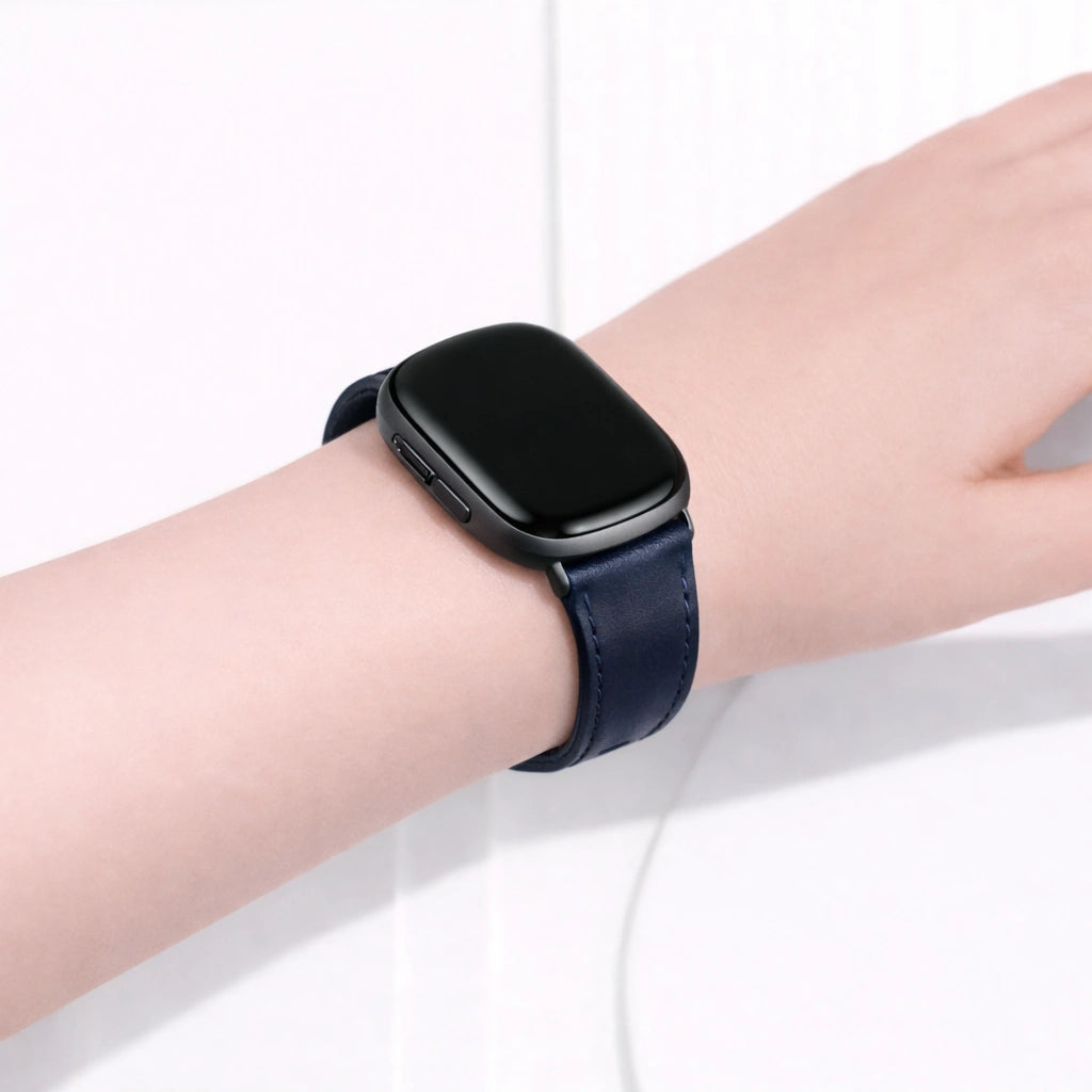 Navy leather band for Fitbit Versa 3 worn on the wrist, showing a comfortable and secure everyday fit.