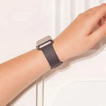 Black silicone strap for Apple Watch SE shown on wrist, suitable for everyday wear