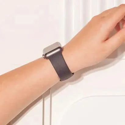 Black silicone strap for Apple Watch SE shown on wrist, suitable for everyday wear