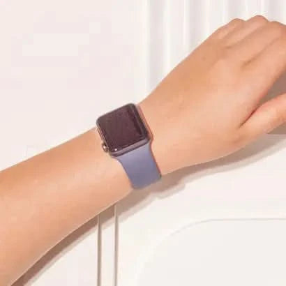 Dark grey silicone Apple Watch SE strap worn on wrist, designed for all-day comfort.