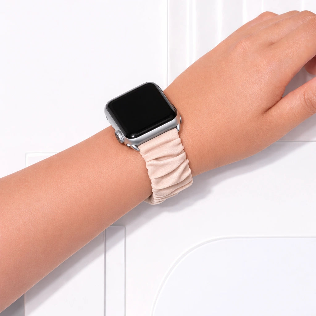 Beige pink scrunchie Apple Watch watch strap worn on wrist with soft elastic fabric design