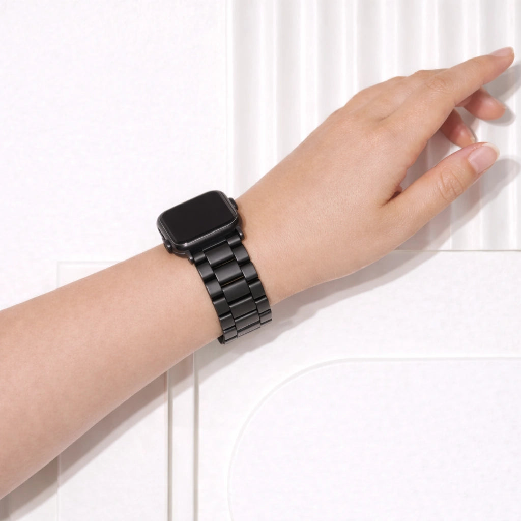 Black stainless steel Apple Watch band in metal link style worn on wrist