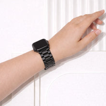 Black stainless steel Apple Watch band in metal link style worn on wrist