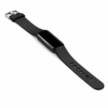 Black Fitbit Luxe watch band attached to tracker with matte finish and silver clasp