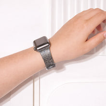 Black glittery Apple Watch wristband worn on wrist with subtle shimmer finish