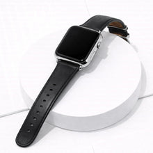 Premium black leather Apple Watch wristband displayed on a white platform.