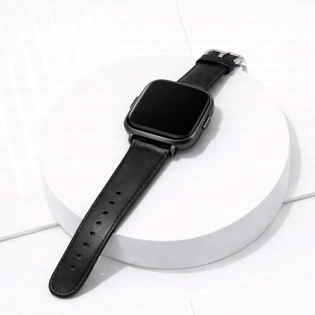 Black leather band for Fitbit Versa 2 displayed on white stand