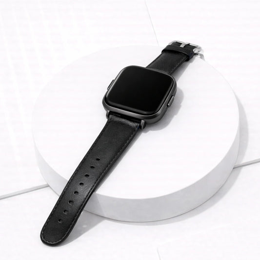 Black leather band for Fitbit Versa 2 displayed on white stand