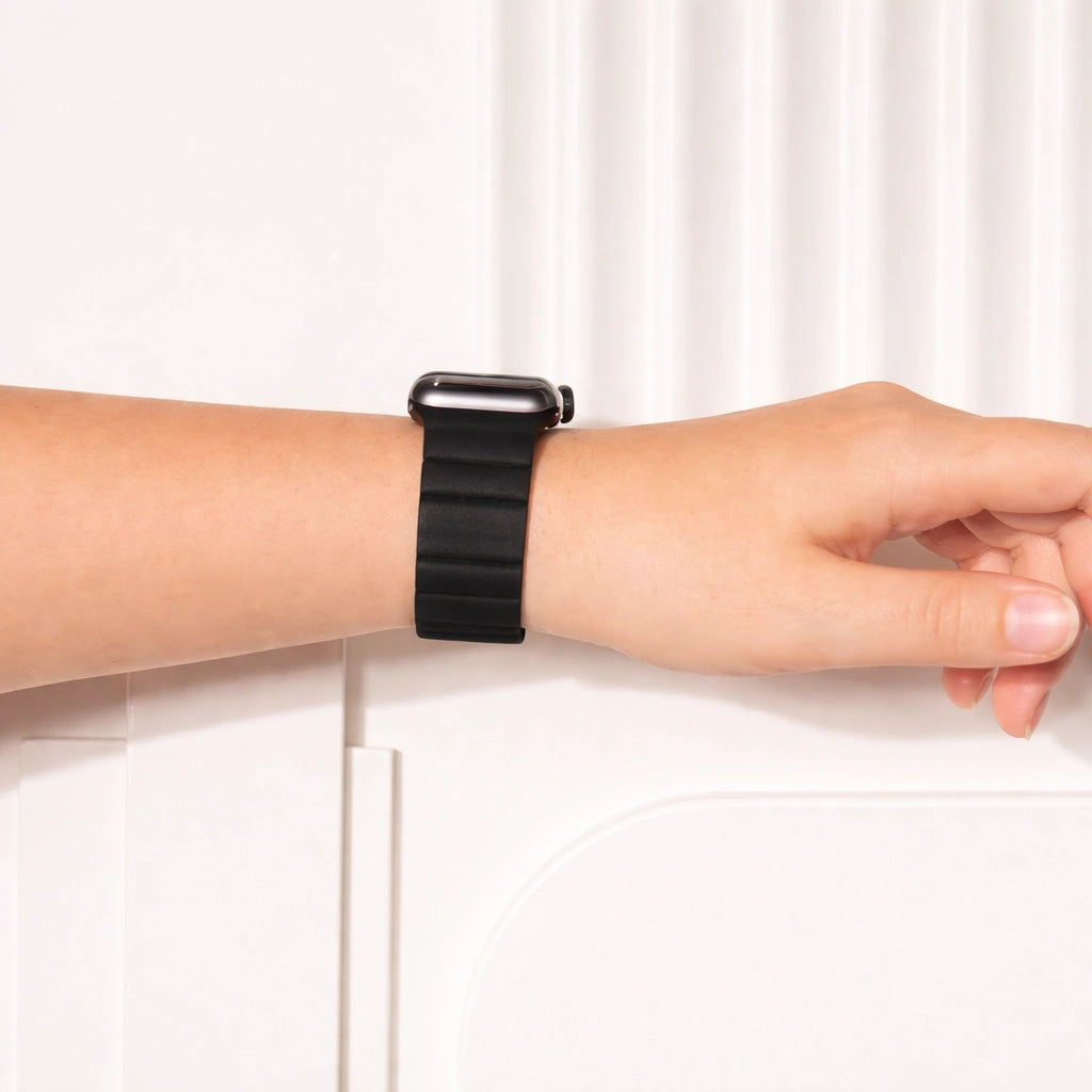 Black leather and silicone Apple Watch band worn on the wrist.