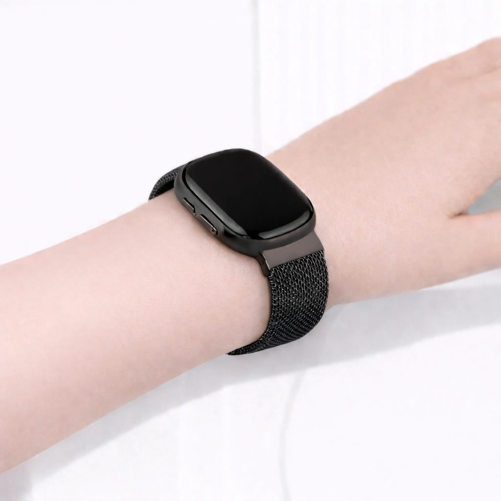 Close-up of a black mesh watch strap for Fitbit Versa 3 on the wrist with a smooth, comfortable fit