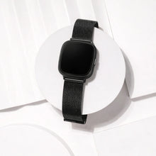 Black mesh Fitbit Versa 4 strap displayed in a clean studio setting