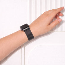 Black metal Apple Watch strap shown on the wrist with a slim mesh finish