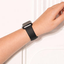 Black silicone Apple Watch band worn on wrist with soft flexible fit