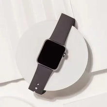 Black Apple Watch SE strap displayed flat, made from soft and durable silicone