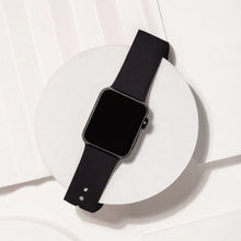 Black silicone watch strap for Apple Watch displayed on white background