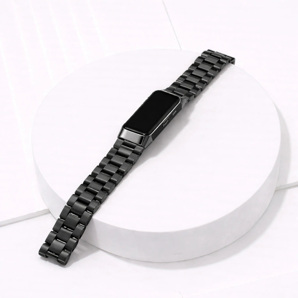 Fitbit Charge 5 black metal watch strap with stainless steel links on white platform