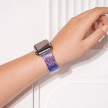 Blue sparkly Apple Watch wristband worn on wrist with shimmering gradient finish