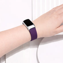 Dark purple watch strap for Fitbit Charge 6 worn on the wrist